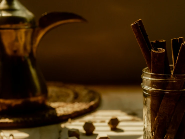 some cinnamon sticks in the jar and a pot with it