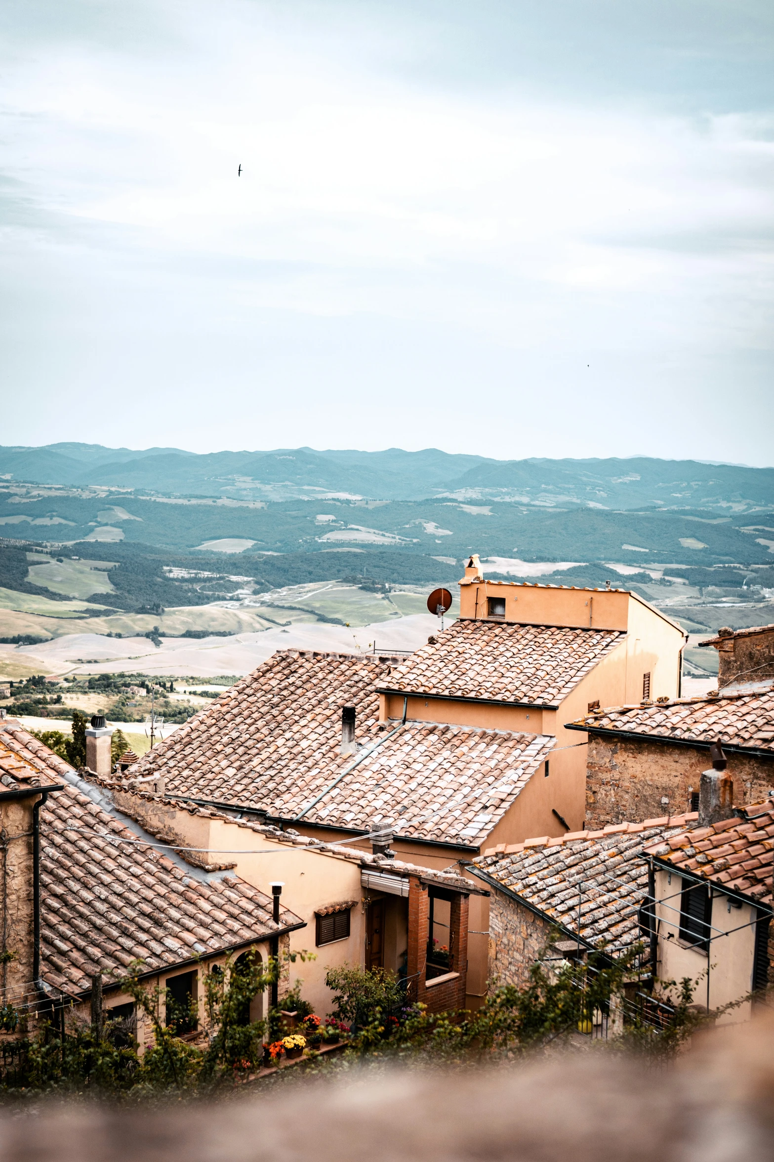 a view of some old buildings with stone roofs