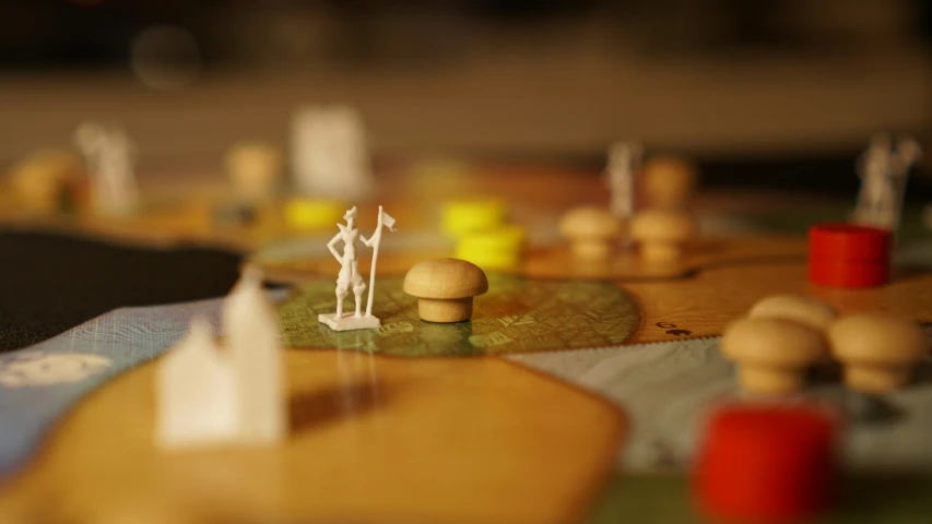 miniature figurines placed on top of an old board game