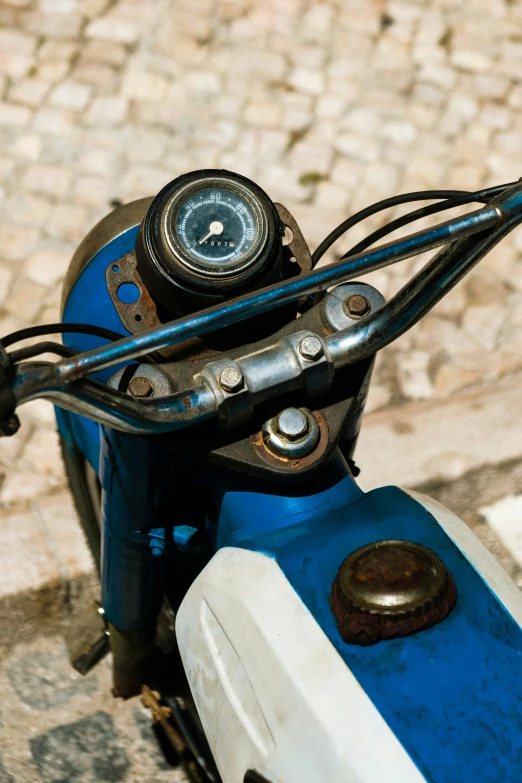 the front end of a motorcycle on cobblestone road