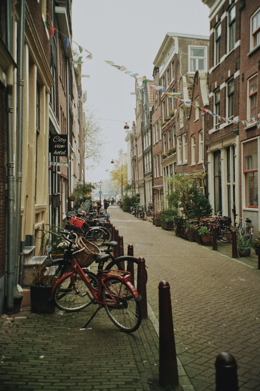 a bike leans up against the sidewalk on the city street