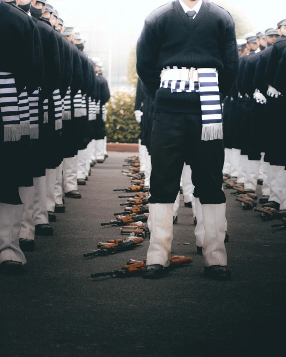 a man standing among a crowd of military men