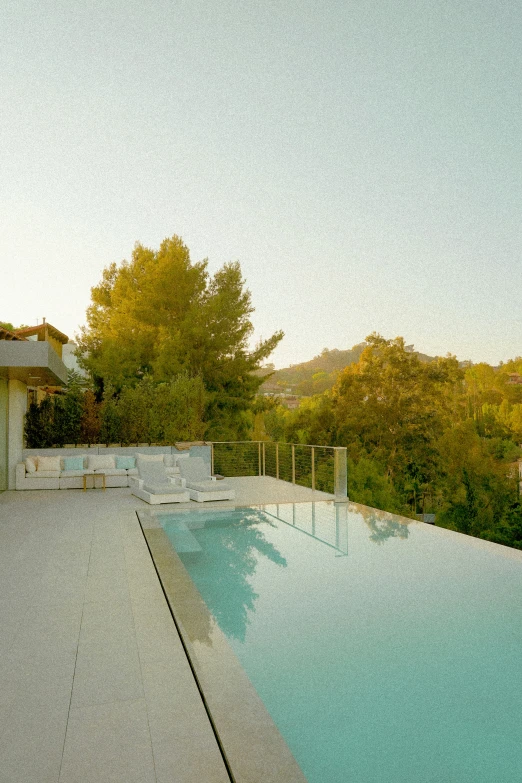 a pool surrounded by a wooden deck and mountains