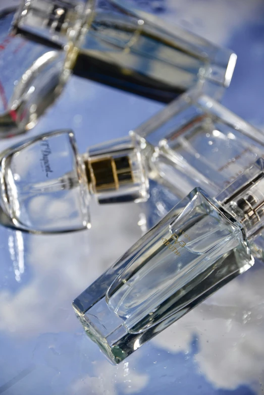 two empty perfume bottles sitting on top of a table