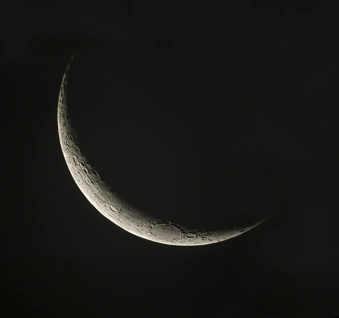 the crescent moon in black and white with stars