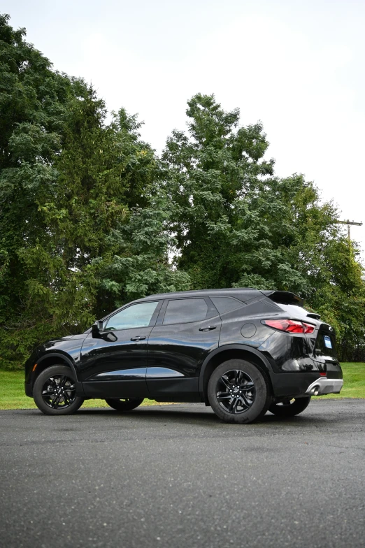 the front view of a black suv with large tires on the road