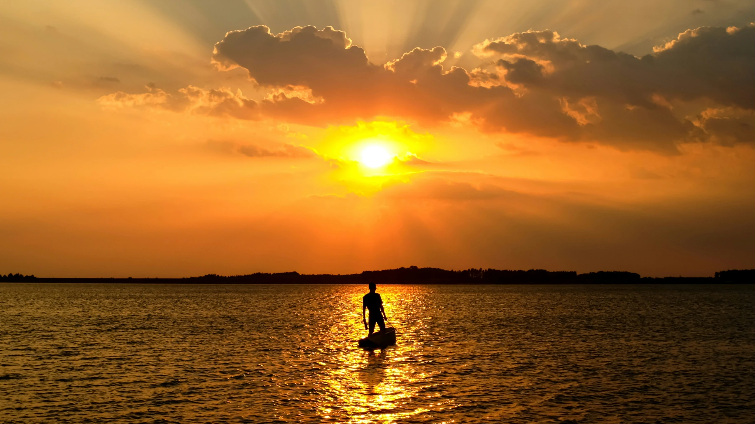 there is a man that is standing on a board in the water