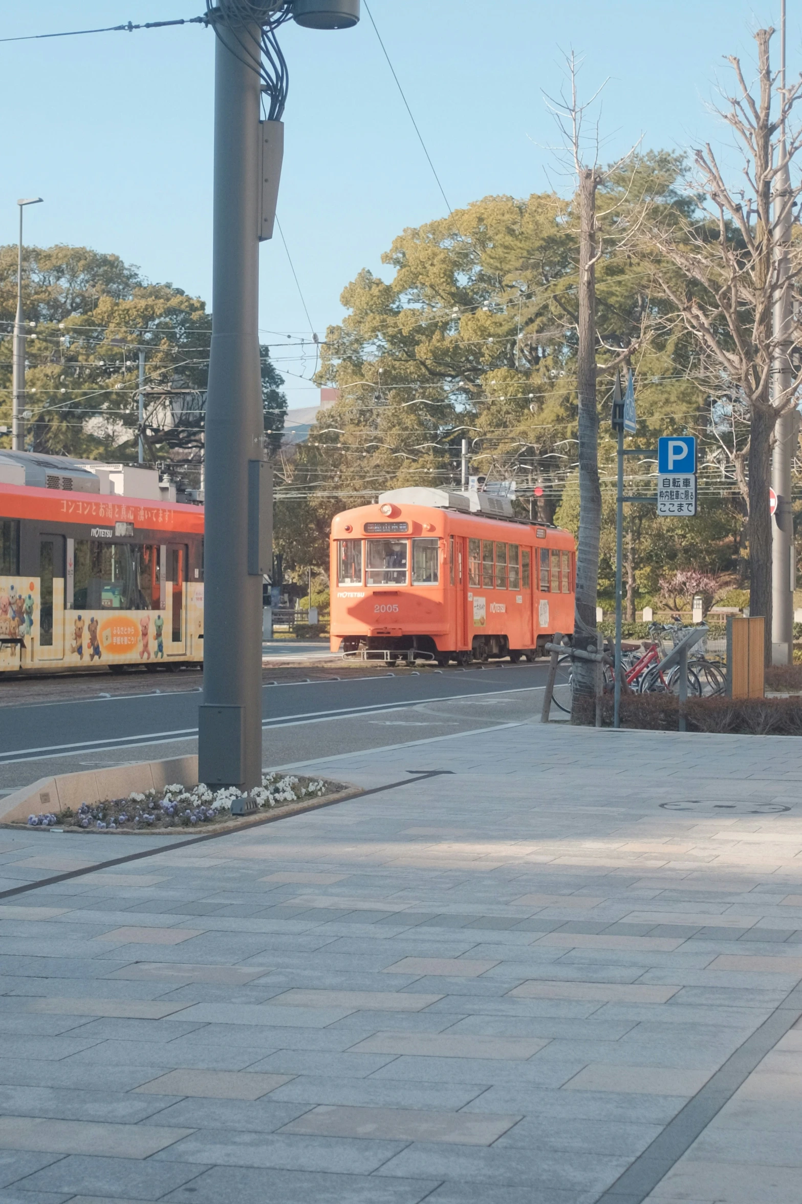 the two orange trains are going down the train tracks