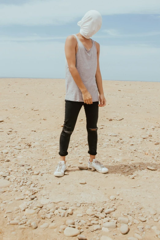 a person standing in the middle of a dry grass covered desert