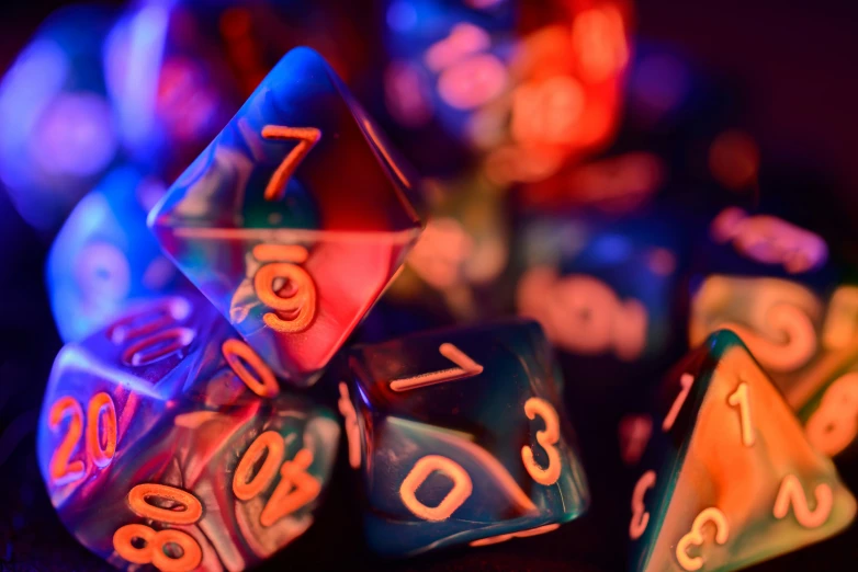 illuminated multi - colored dice laying on the surface