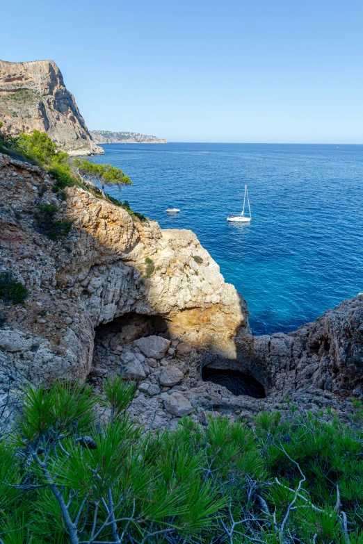 a boat sailing by near some very blue ocean