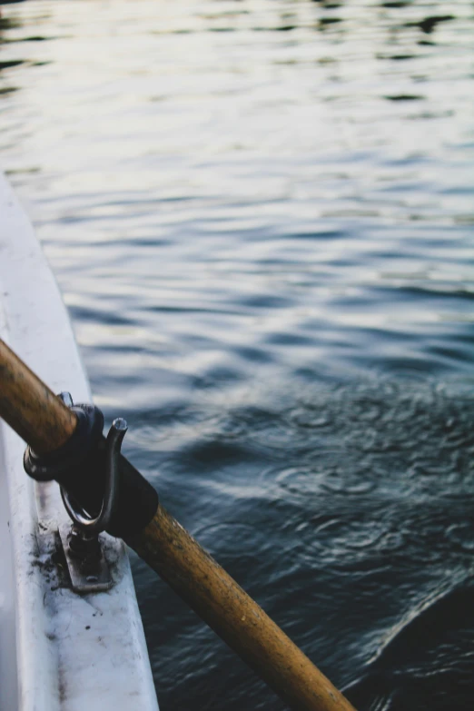 a raft handle holding onto the side of a boat on water