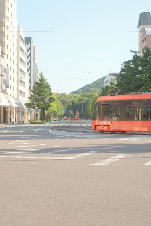 the bus is going down the street behind the buildings