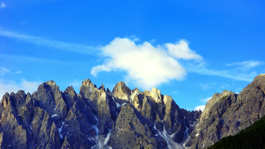 a mountain view with mountains in the background and clouds above