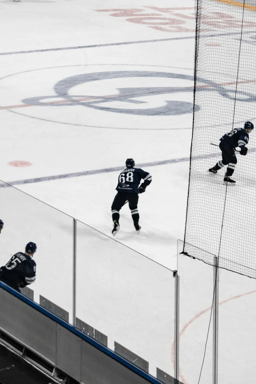 hockey players are on the ice playing an ice - hockey game