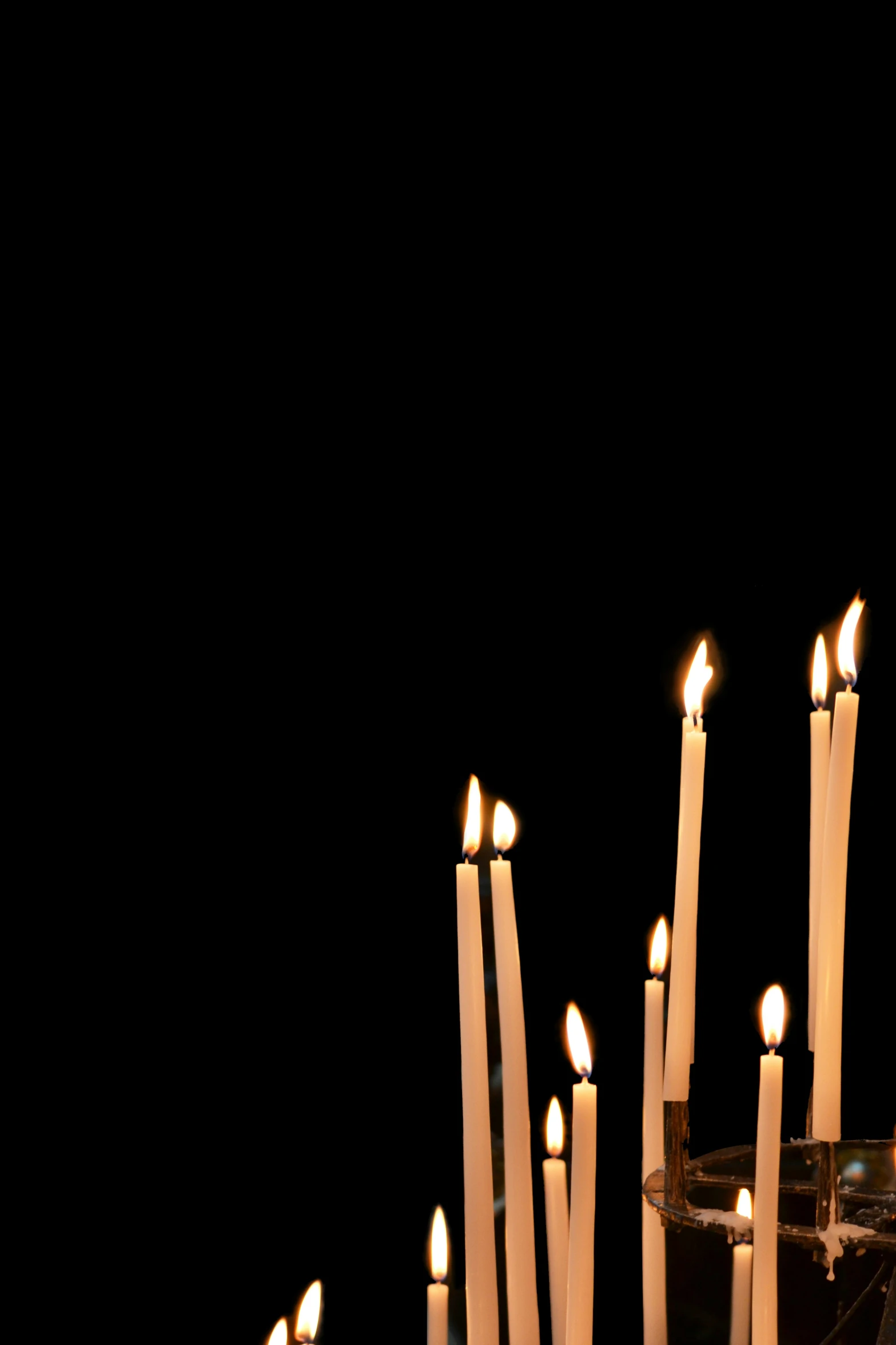 an arrangement of lit candles on a table