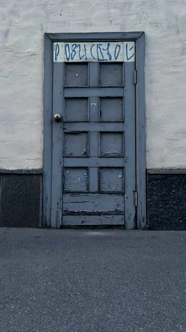 a door with a sign and some writing on it
