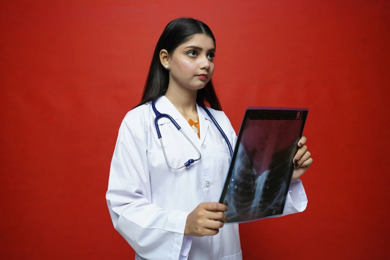 a female doctor holding a x - ray image in her hands