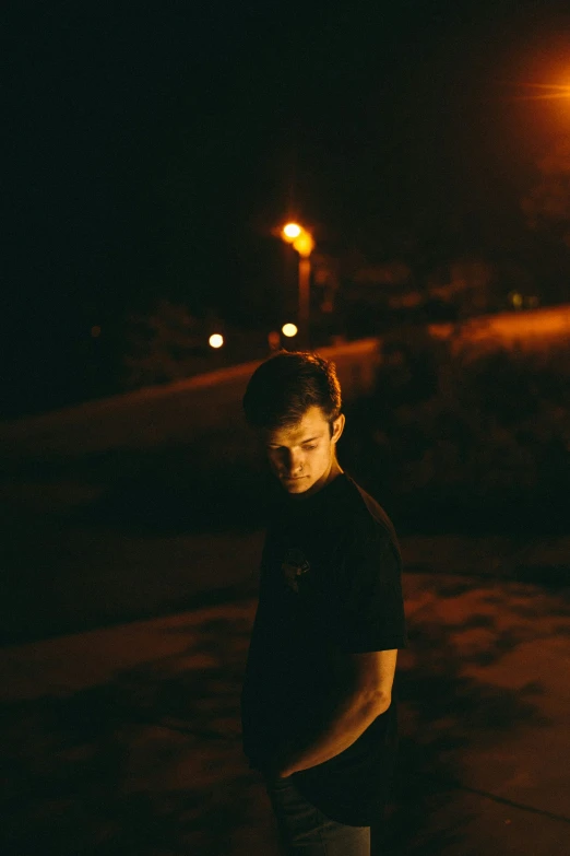 a man that is standing up by some street lights