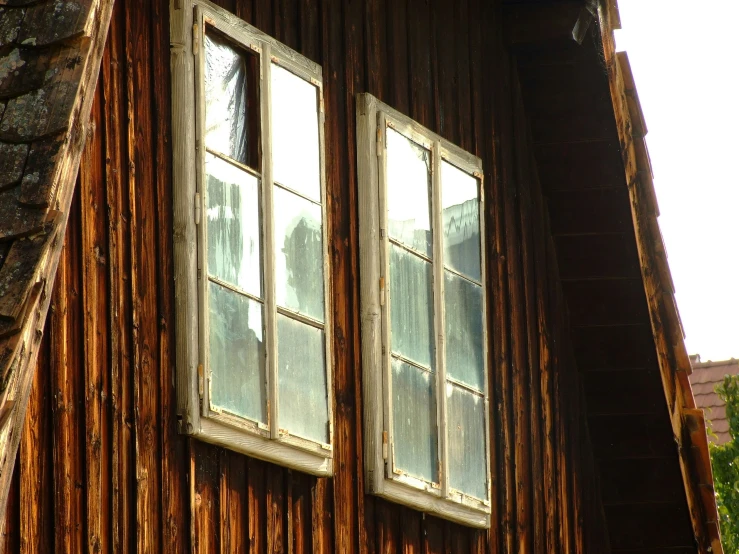 a small window in front of a wooden building