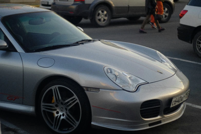 a grey sports car parked in parking space