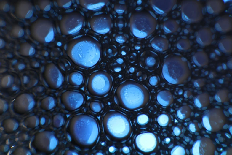 a close up picture of some dark colored bubbles