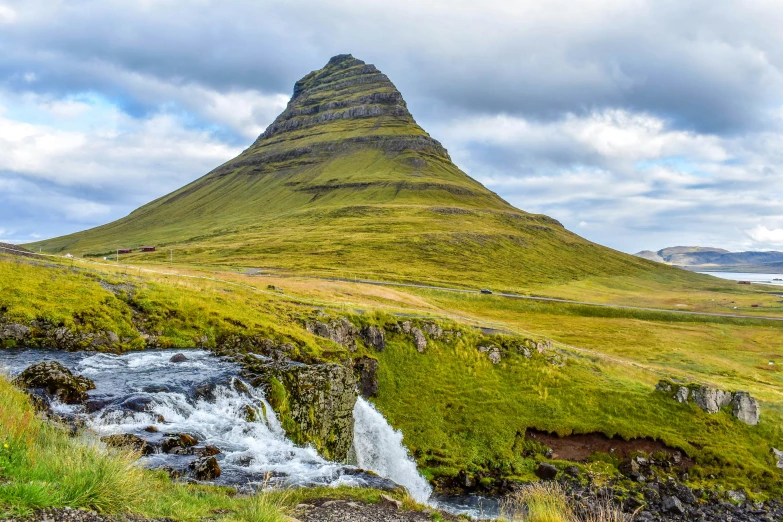 a mountain with a stream in front of it