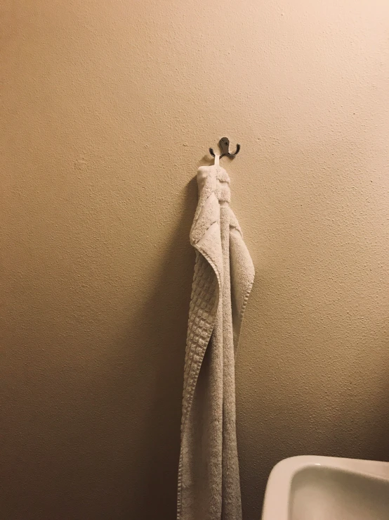 a towel is hanging in a bathroom next to a toilet