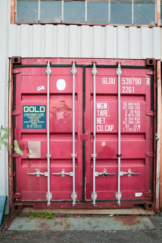 this large container is made from a old red shipping container