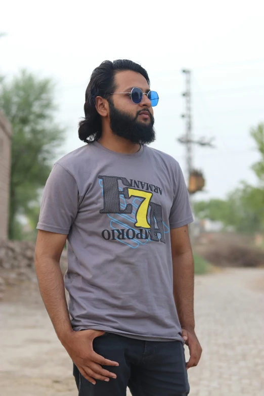 a man with long hair and beard standing in a street