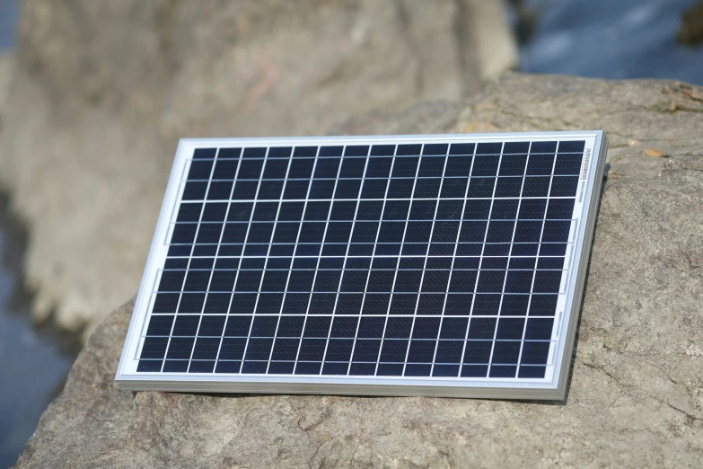 a very nice looking solar panel by some water