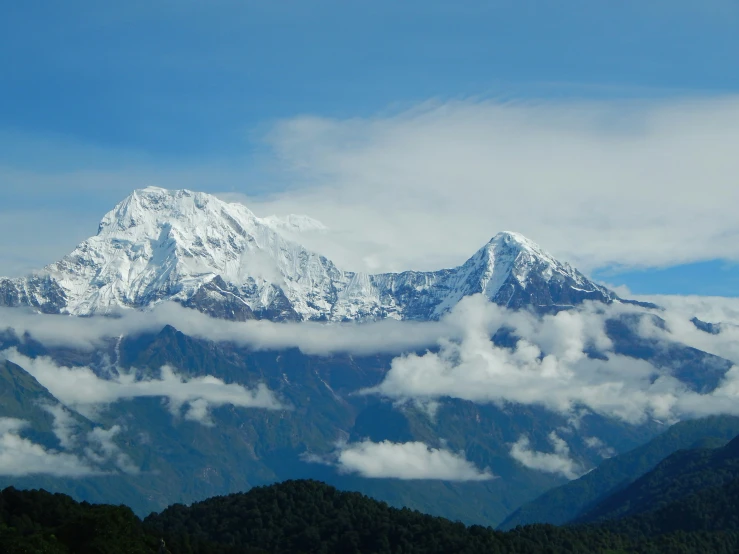 a very tall mountain covered in cloud covered mountains