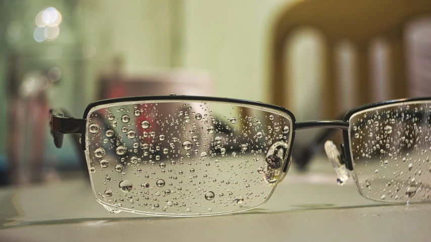 a pair of glasses covered in rain