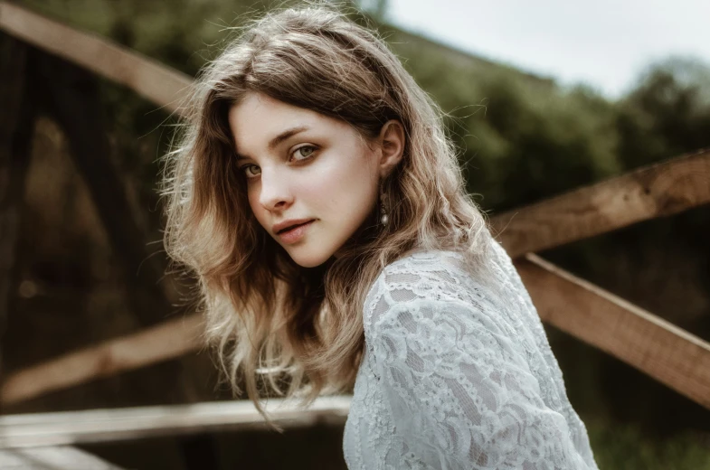 an attractive young woman wearing white posing for a po