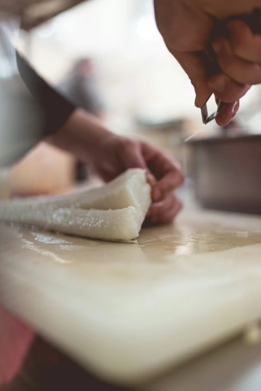 the person is in a kitchen preparing food on the counter