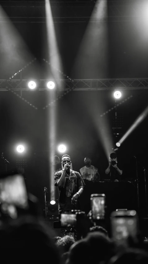 a man standing on top of a stage with several lights