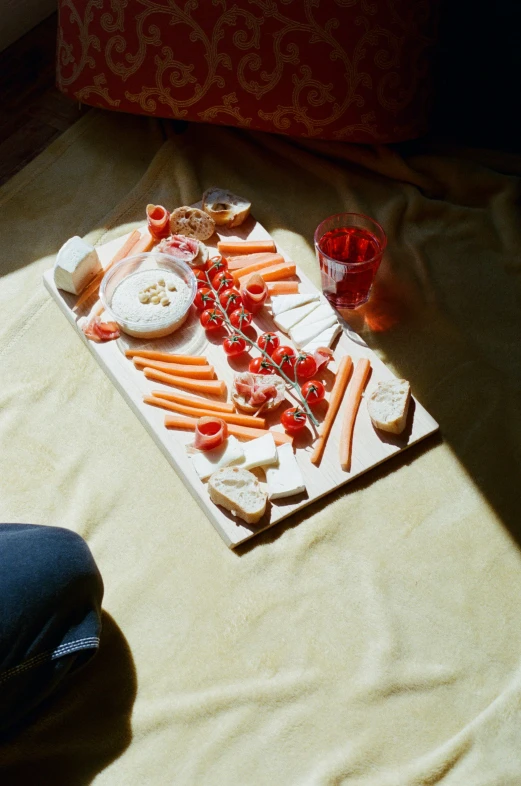 the woman is setting up an elaborate cheese and fruit platter