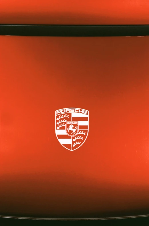 the emblem on a red car's bumper plate shows an ornate design