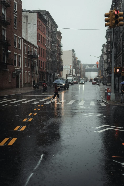 someone in black walking down the street at an intersection