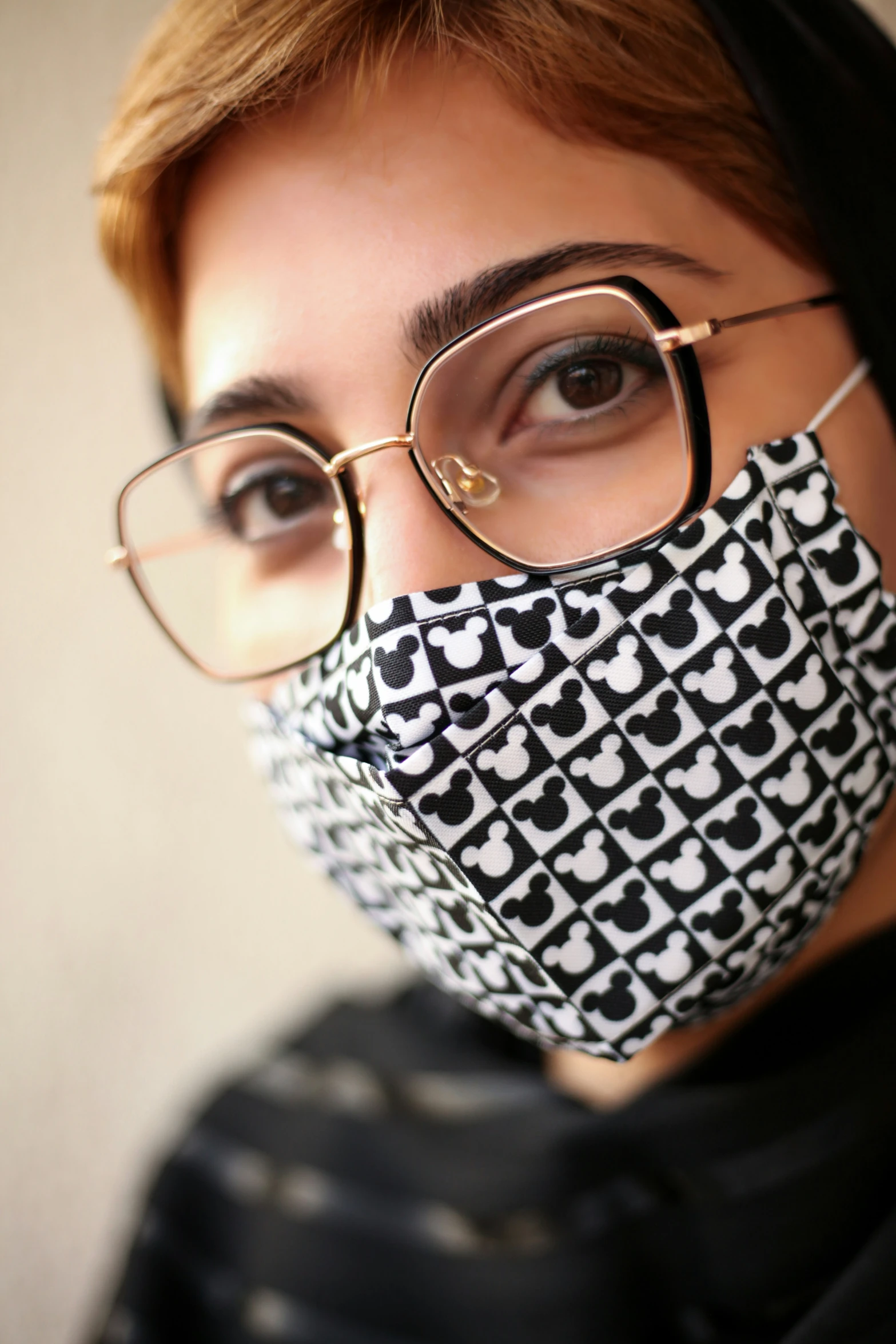 a woman wearing glasses and an over sized face mask