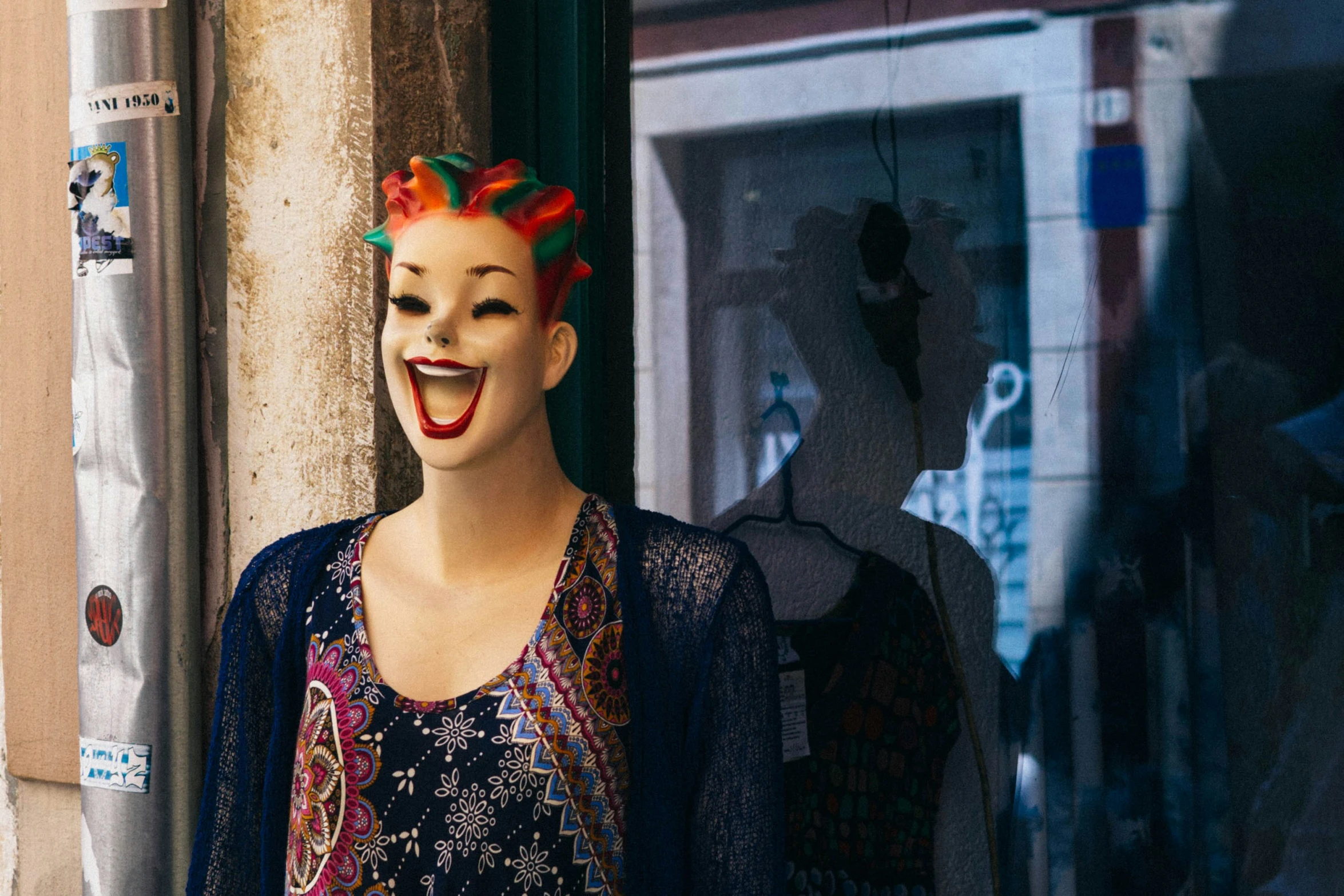 a mannequin with orange and red hair with a creepy smile