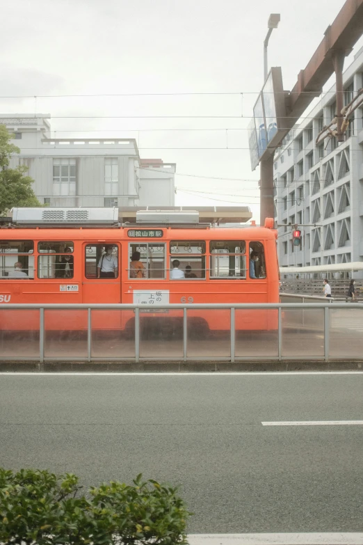 the electric train is parked near a fence