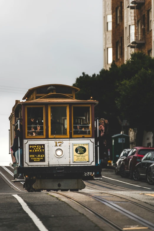 a trolley driving down a street with lots of cars in it