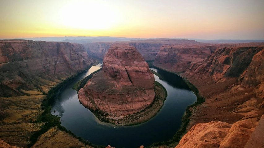 river flowing between some cliffs with sunset