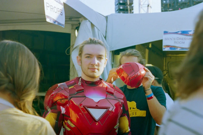 the man is in a red and yellow suit holding out his hands