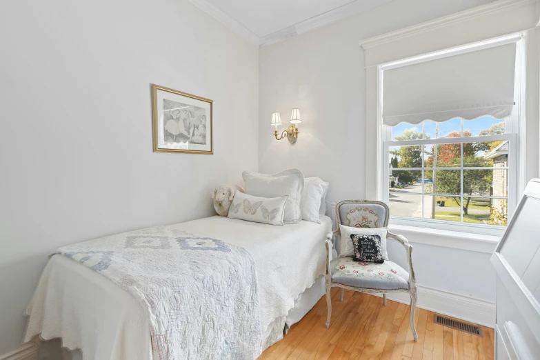 an old fashioned bedroom with a white bed and wooden floor