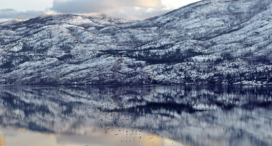 a mountain that is covered in snow and water