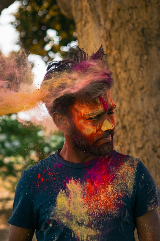 a man with splatkled paint on his face