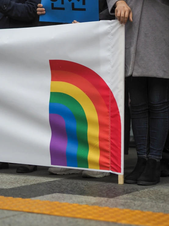 a couple of people standing next to each other holding signs