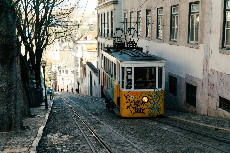 a cable car is parked on the street in front of buildings